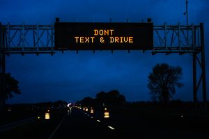 text and drive warning over highway