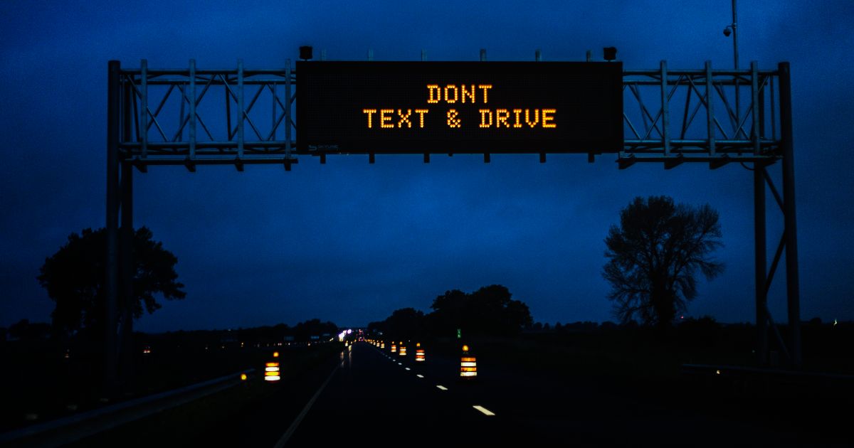 text and drive warning over highway