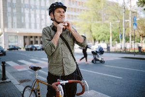 bicyclist strapping on helmet