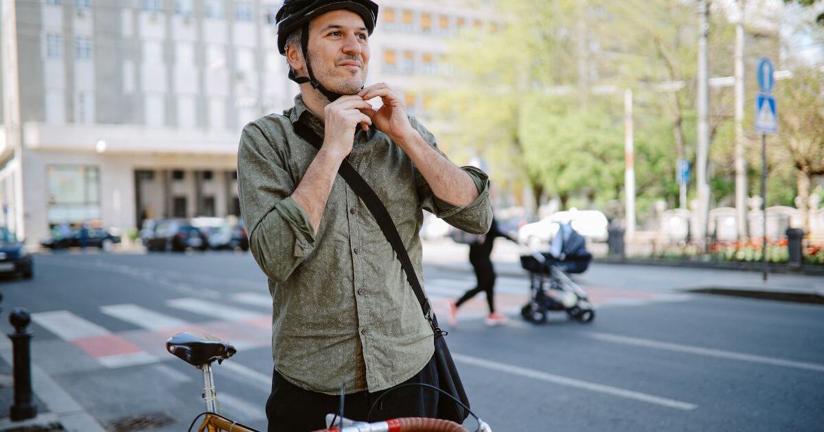 bicyclist strapping on helmet