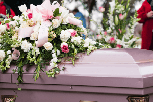 casket with flowers on top of it