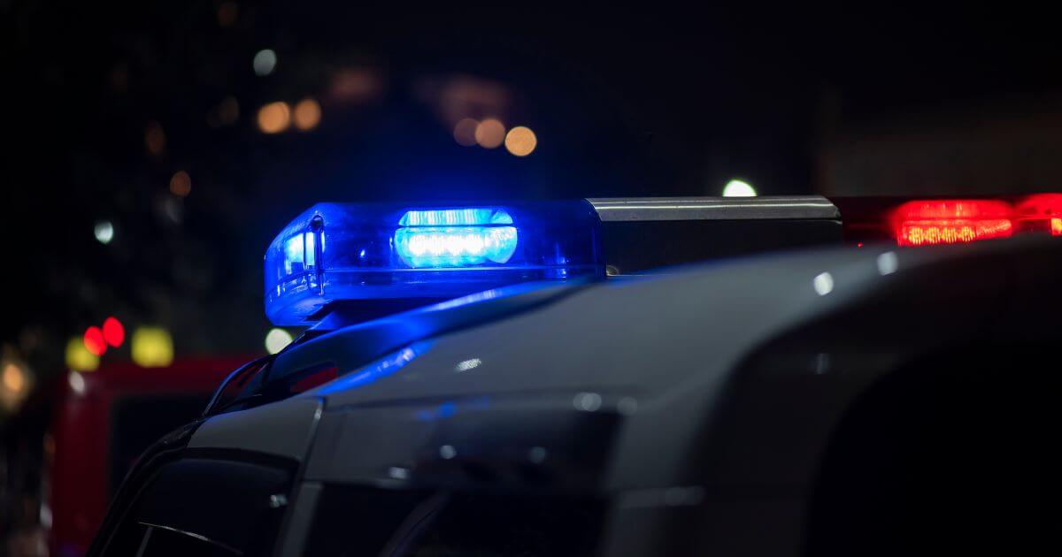 police car at night with lights on