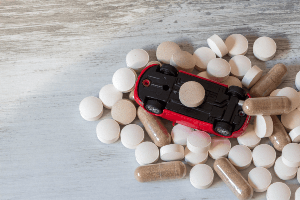 pills surrounding upside down toy car
