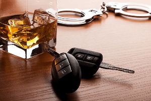 car keys, handcuffs and glass of alcohol