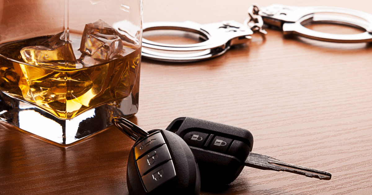 car keys, handcuffs and glass of alcohol