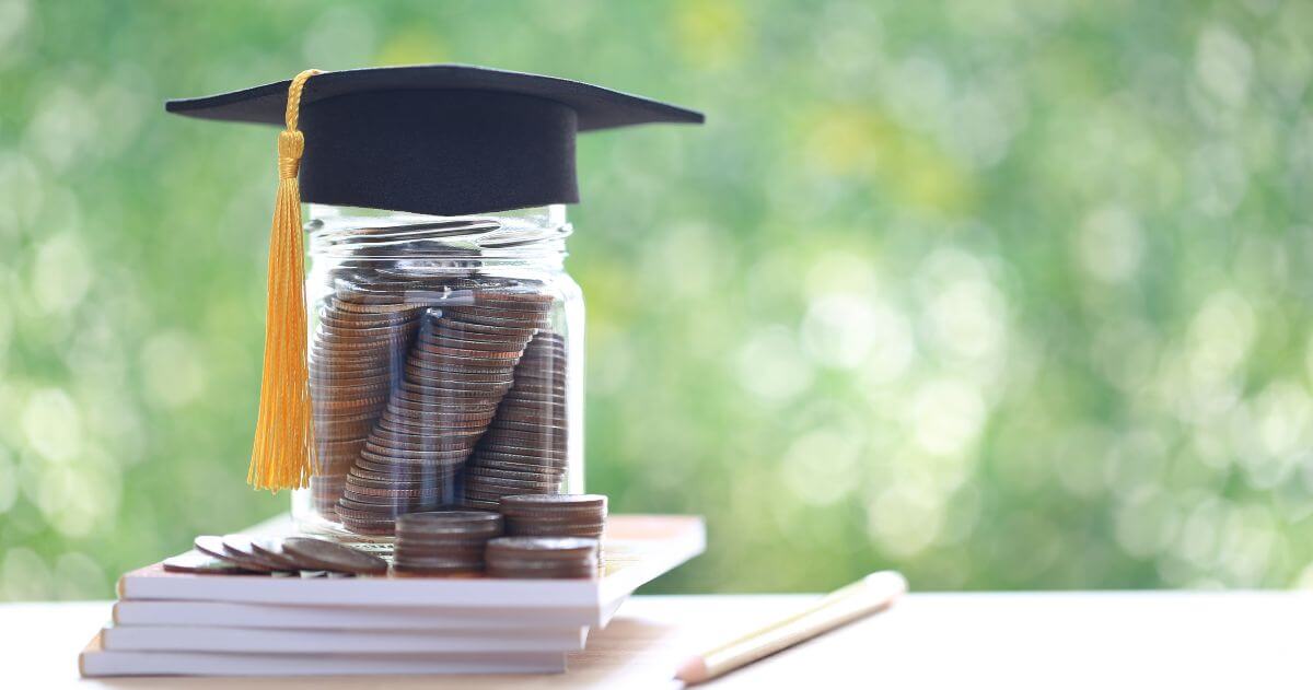 tasseled hat with jar of quarters