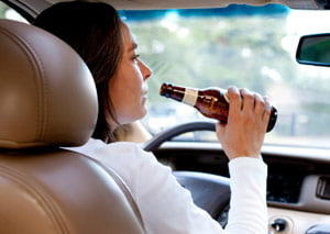 driver that is drinking an alcoholic beverage