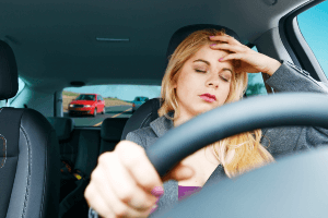 driver with hand on forehead