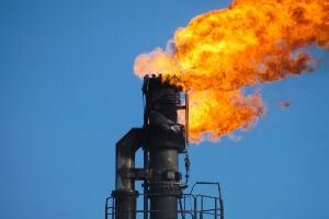 fire at oil refinery during daytime