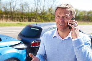 man on phone after a car crash