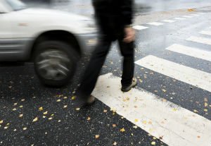 person walking across a pedestrian crossing