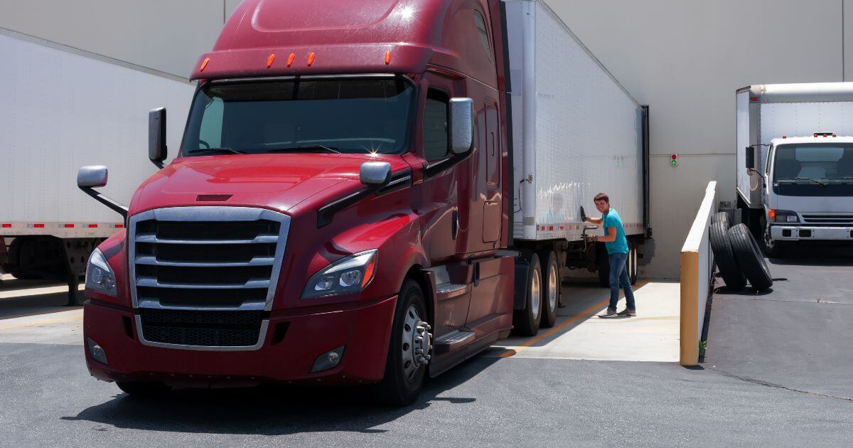 red commercial truck at warehouse