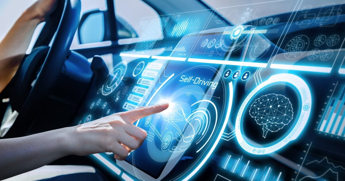 close-up of a driver's hands pointing at automotive software screen on the dashboard